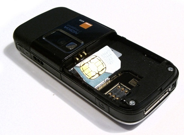 A mini-SIM card next to its electrical contacts in a Nokia 6233